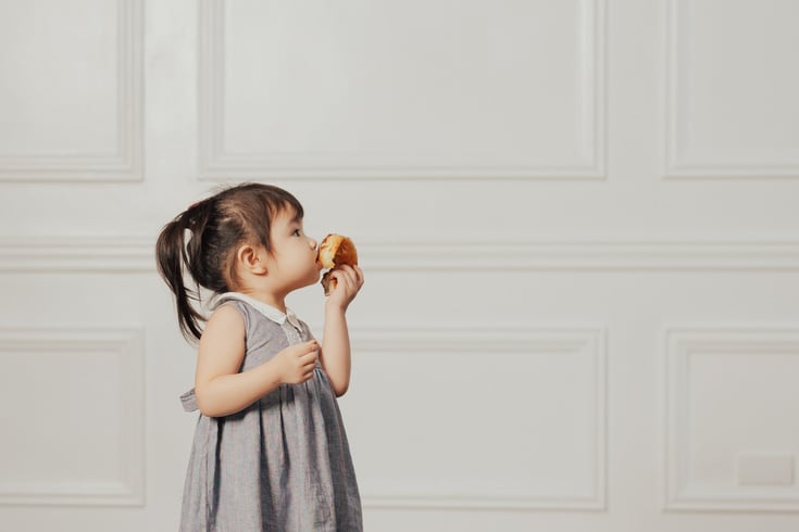 Little Girl Eating Donut